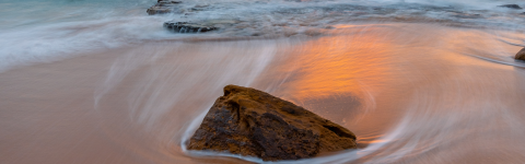 rock on a beach with waves