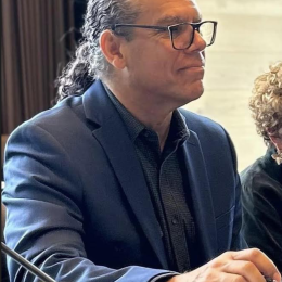 Photo of Roger L. Worthington wearing glasses and a blue blazer over a gray shirt.
