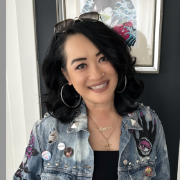 Dr. Zamora Liu posing by wall