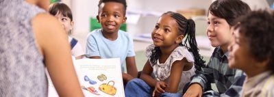 Woman Reading to Children