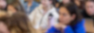 Blurred image of students sitting at desks