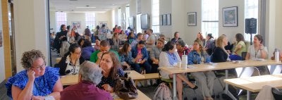 Crowds of people talking at a conference