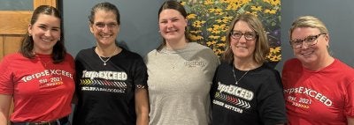 TerpsEXCEED staff in red, black, and grey logo shirts