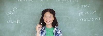 Girl in front of chalkboard with written parts of speech