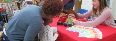 Kelsey Showing Puppets at CYC Meet and Greet