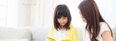 Parent reading to school child