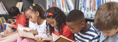 Diverse students read in a library