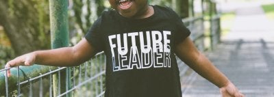 A young girl wearing a shirt that says "Future Leader"