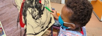 Child painting outside
