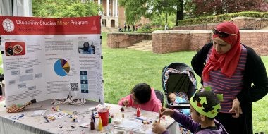 A family engages in an art activity organized by the College of Education's Disability Studies Minor at Maryland Day 2023.