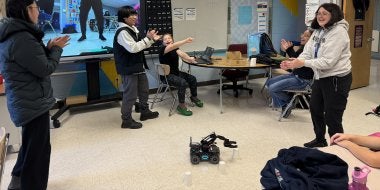 Students at A. Mario Loiederman Middle School participate in a robotics demonstration at the  Co-Learn Code and Mind afterschool program.