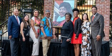 Elaine Johnson Coates '59 meets artist Ernest Shaw Jr. and gets the first glimpse of her portrait at the College of Education's 2024 Alumni of Color Celebration