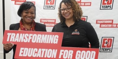 EdTerps hold up a sign reading "Transforming Education for Good" on Giving Day 2026.