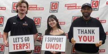 EdTerps hold up signs reading "Let's go Terps," "I support UMD" and "Thank you" on Giving Day 2026.