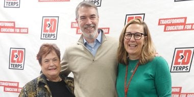 College of Education faculty members celebrate Giving Day 2026 in front of a banner that reads "EdTerps: Transforming Education for Good."