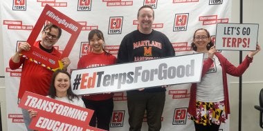 EdTerps hold up signs reading "#GivingDayUMD," "Transforming Education for Good," "#EdTerpsForGood" and "Let's Go Terps" on Giving Day 2026.