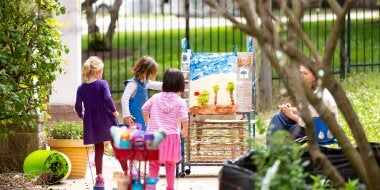 Children paint outside their classroom. 
