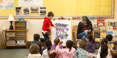 A child points to different pistons while learning about their car study.
