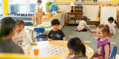 Children play a counting game in the classroom.