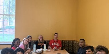 TerpsEXCEED Students and Mentors gathered around a table at 251 Dining Hall