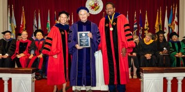 Greg Hancock receiving the designation of Distinguished University Professor at 2026 Faculty and Staff Convocation, with Provost Jennifer King Rice and President Darryll J. Pines