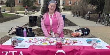 TerpsEXCEED Student in Pink Clothes tabling for ZTA think pink campaign