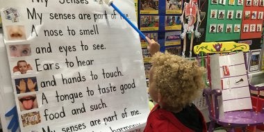 Child Pointing at Poster