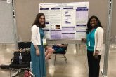 Lab Members presenting a poster at a conference