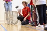 A student prepares to test a sail car in an instant design challenge at the 2023 Maryland Regional KidWind Challenge.