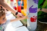 A child places a handprint on a pole as part of a community-based art project led by the Lakeland community of College Park, Clinical Associate Professor Margaret Walker, and College of Education graduate students.