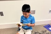 Young Boy Reading book - Summer Reading program