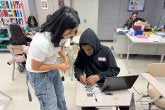 Two students at A. Mario Loiederman Middle School collaborate on a robotics project at the Co-Learn Code and Mind afterschool program.