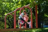 Children swing on the tire swing on the playground.