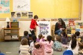 A child points to different pistons while learning about their car study.