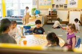 Children play a counting game in the classroom.