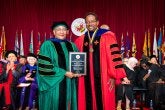 Anisha Campbell receiving a President's Distinguished Service Award at the 2026 Faculty and Staff Convocation, with President Darryll J. Pines