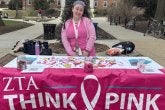 TerpsEXCEED Student in Pink Clothes tabling for ZTA think pink campaign