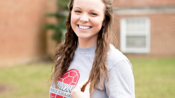 student standing outside smiling