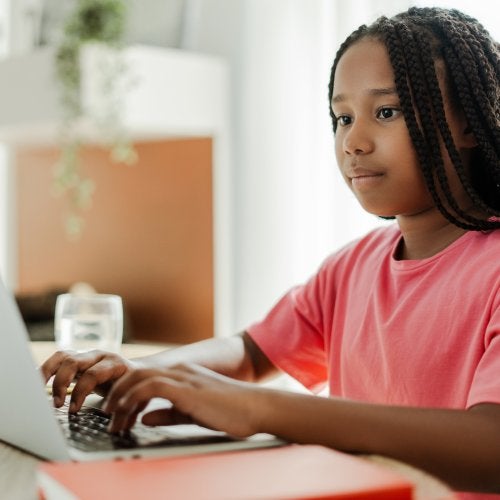 A Black girl using a laptop