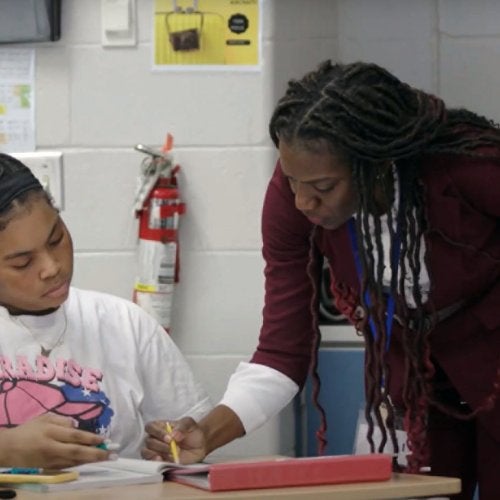 Teacher Mitchelle McLeod works with a student in her math class.