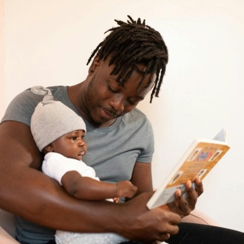 A dad reads to his baby.