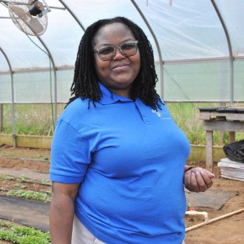 Truphena Choti Ph.D. '09, CEO of the nonprofit AfriThrive, stands inside a greenhouse in Dickerson, Md., where the organization grows indigenous African vegetables for the community.