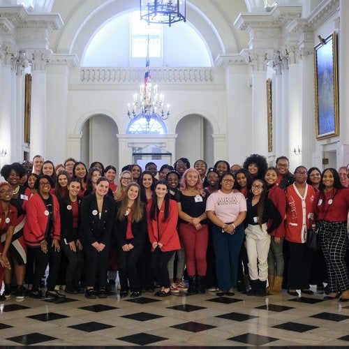 Students and faculty stand in the rotunda of the Maryland State House