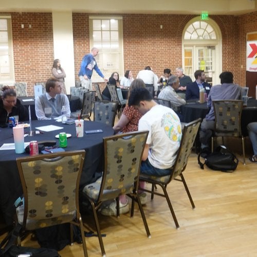 Participants at “Who Has the Power? The Constitution and Our Role in Securing Democracy" engage in small group discussion at tables in the Stamp Student Union.