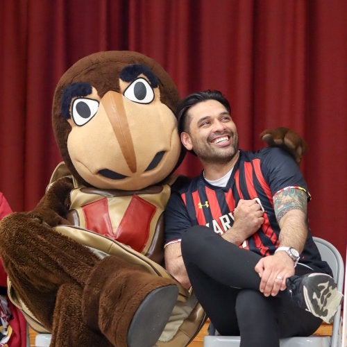 Testudo embraces P.E. teacher Sergio Cabrera ’14, M.Ed. ’17 during a surprise school visit for Teacher Appreciation Week.