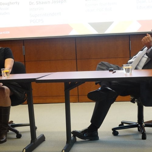 Deirdre Mayer Dougherty and Alvin Thornton sit together at a table and engage in conversation.