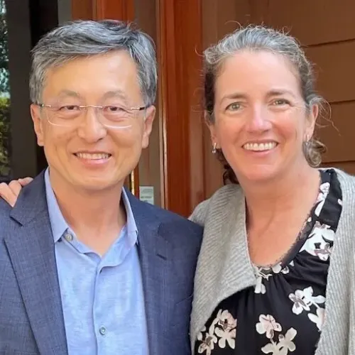 MILE donors Ho Nam and MR Macgill stand next to each other, with Macgill's hand on Nam's shoulder.