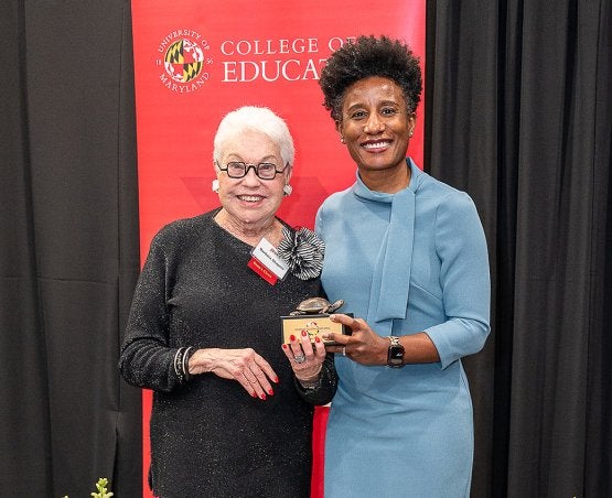 Barbara K. Shapiro ’55 receives a Dean's Circle trophy from Dean Kimberly Griffin