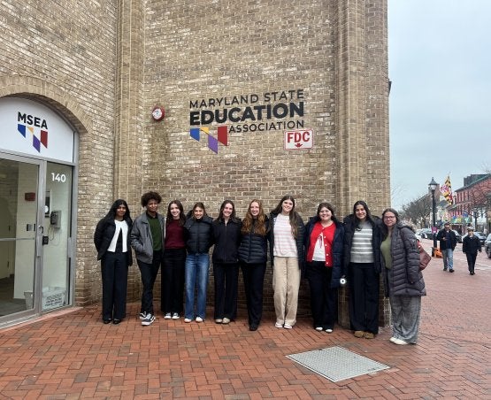 Students representing the Teacher Education Association for Maryland Students (TEAMS) stand outside the Maryland State Education Association headquarters.