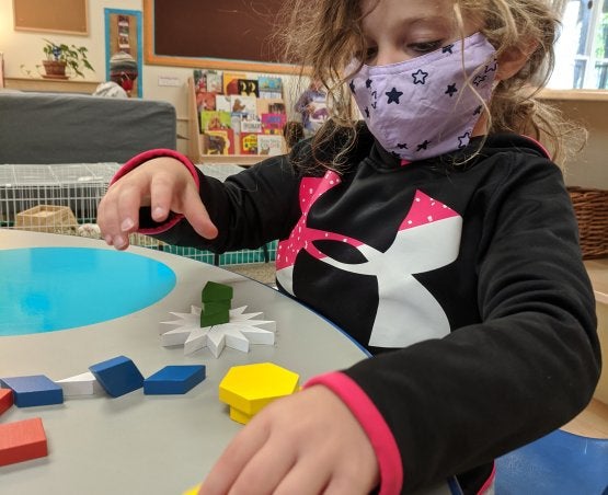 Child playing with pattern blocks